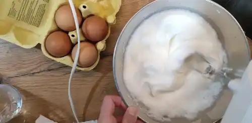 Whisk the egg whites until stiff.