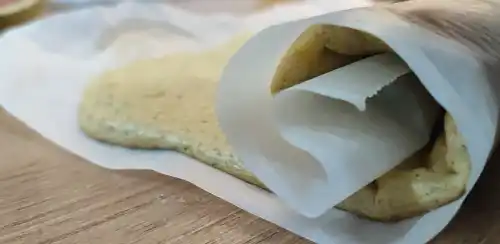 roll the cake into a swiss roll shape