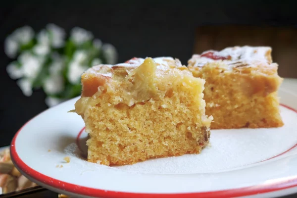 Easy rhubarb sponge cake fresh out of the oven, golden brown and topped with tangy rhubarb pieces, perfect for any occasion.