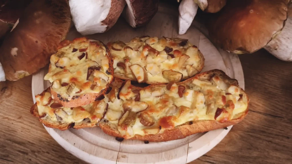 Porcini Mushroom Cheese Topped Bread served on a wooden board