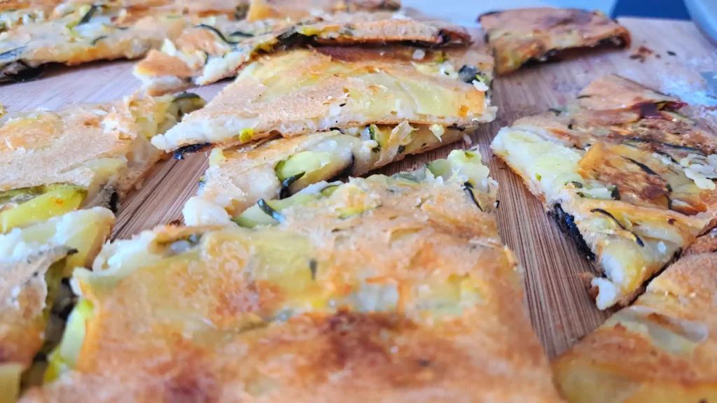 Zucchini Scarpaccia Recipe with Trumpet Mushrooms served on a cutting board